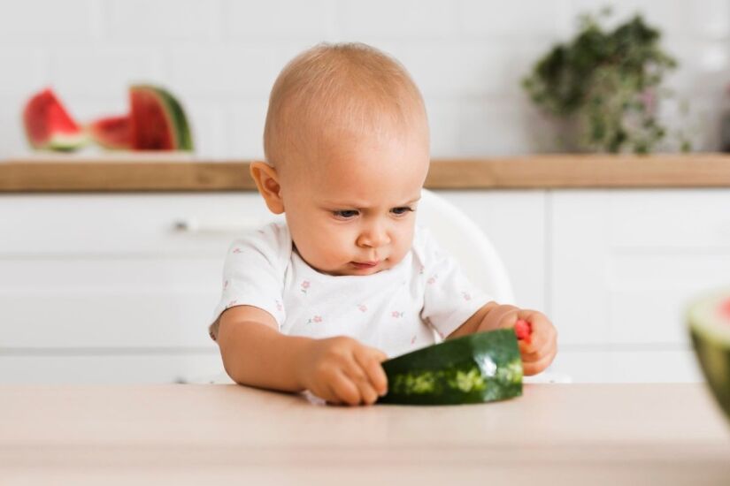 baby eating watermelon